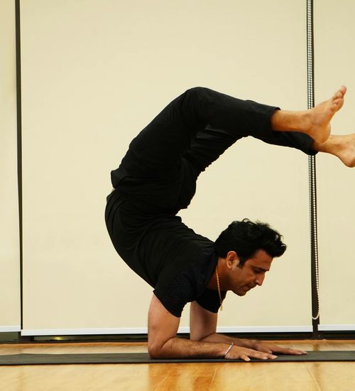 Man focused during a dynamic stretching exercise, showing flexibility and control.